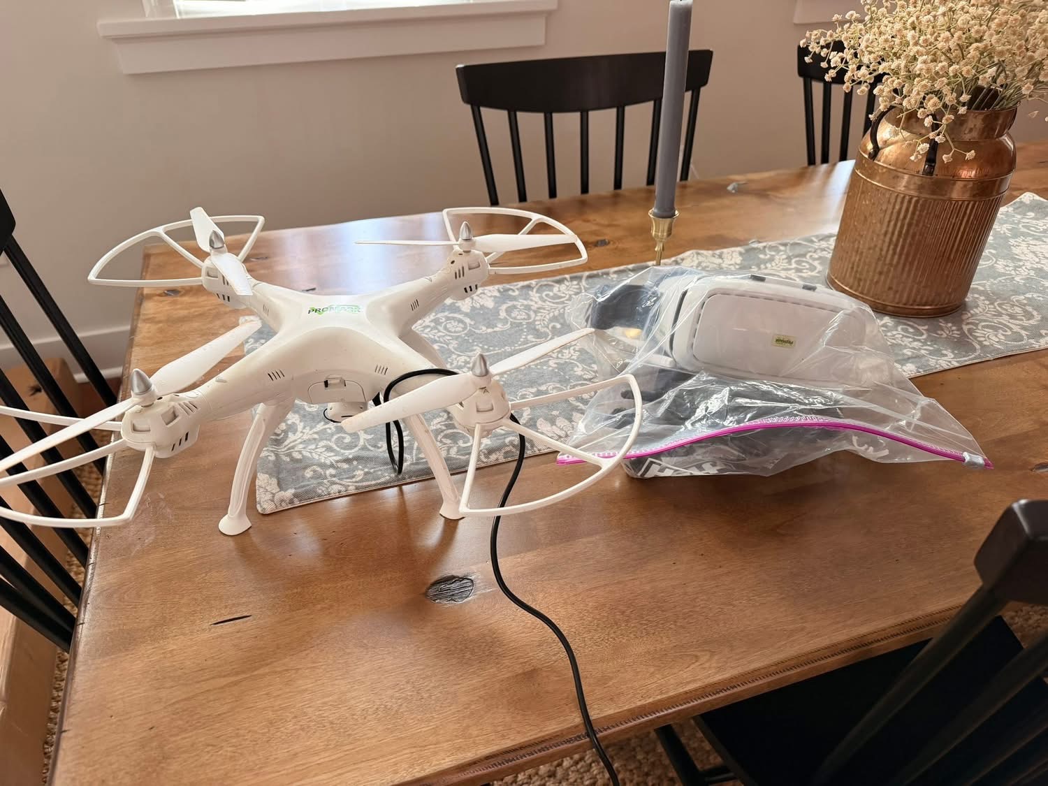 picture of a promark drone and accessories sitting on a table.